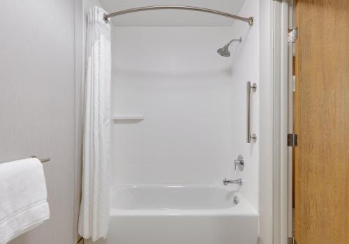 a bathroom with a shower and a white tub at Holiday Inn Express Scottsbluff - Gering, an IHG Hotel in Scottsbluff