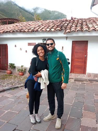 a man and a woman standing in front of a house at Casona Buenavista Andahuaylillas in Andalmailillas