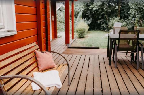 a wooden porch with a bench and a table on it at Haus Hanni Zarrentin am Schaalsee in Zarrentin
