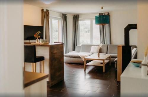 a living room with a couch and a table at Haus Hilde Zarrentin am Schaalsee in Zarrentin