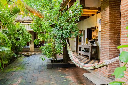 a hammock in the courtyard of a house at Casa Real Del Cabrero by Soho in Cartagena de Indias
