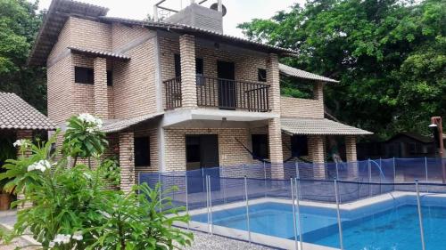 a house with a swimming pool in front of it at RECANTO da LAGOA in Jijoca de Jericoacoara