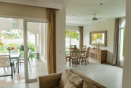 a living room with a couch and a dining room at Private Villa LaPerla Iberosta 3BDR, Pool, Beach, WiFi in Punta Cana