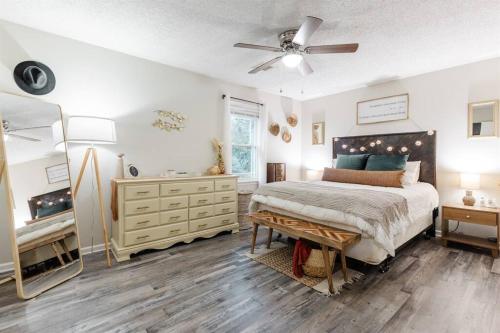 - une chambre avec un lit, une commode et un miroir dans l'établissement Sidney Springs Cottage, 