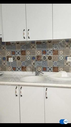 a bathroom with white cabinets and a sink at DURU selimiye konukevi in Selimiye