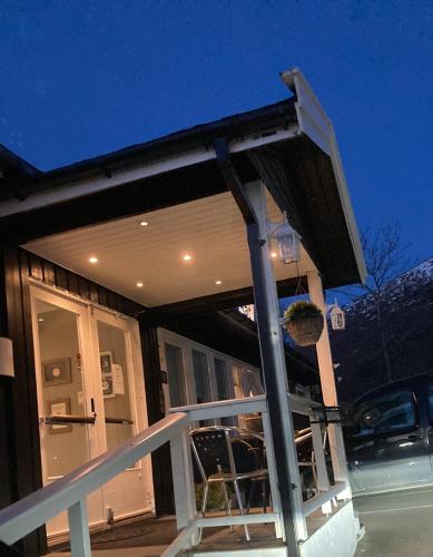 a porch of a house with a car parked outside at Førde Pensjonat in Førde