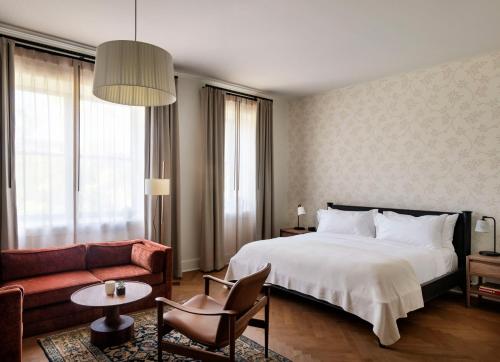 a hotel room with a bed and a couch at The Quoin Hotel in Wilmington