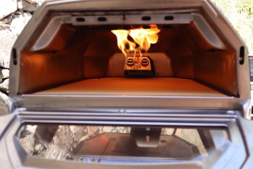 an open oven with fire inside of it at Finca La Sabina in Risco Blanco