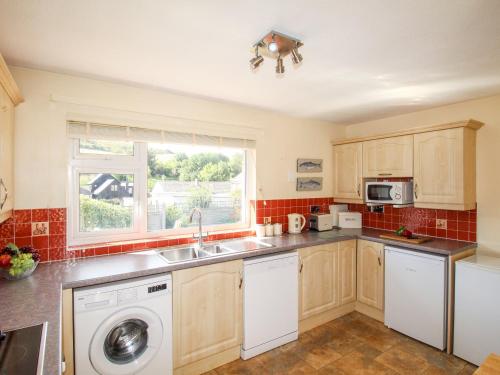 a kitchen with a sink and a dishwasher at Hill View in Wareham