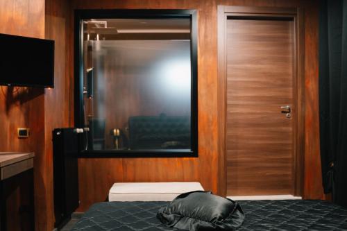 um quarto com uma cama e uma porta de madeira em Dal Patricano em Frosinone