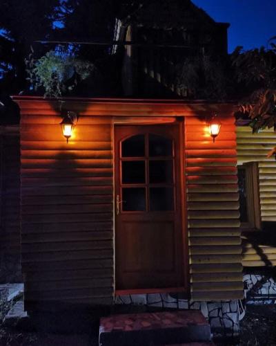 a small cabin with a door and lights on it at Fruskogorski mir in Besenovacki Prnjavor