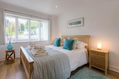 a bedroom with a bed with towels on it at Serendipity in St Ives