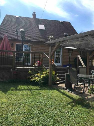 a house with a deck and a table and a patio at A Gem in the Heart of Ottawa in Ottawa