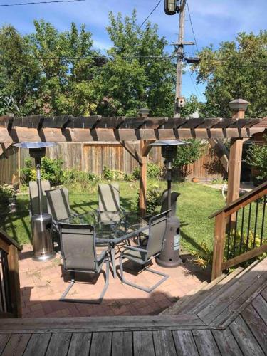 a group of chairs sitting under a wooden pergola at A Gem in the Heart of Ottawa in Ottawa