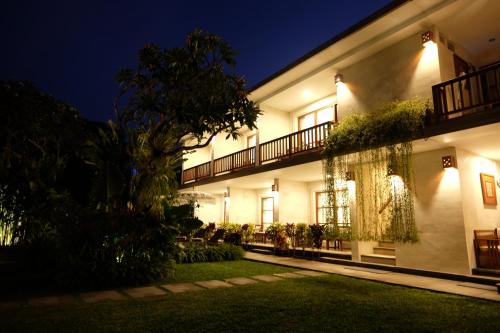 an exterior view of a building at night at Kayu Sugih Palace in Sanur