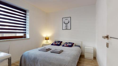 מיטה או מיטות בחדר ב-Apartament Fibra Americano