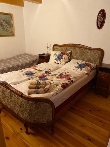 a bedroom with a bed with a floral comforter at Apartma Jožica in Tonček in Sveti Jurij ob Ščavnici