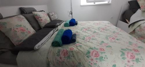 a bed with blue shoes sitting on top of it at Apartman for You in Gyenesdiás