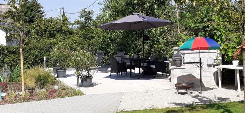 a colorful umbrella sitting next to a stone fireplace at Apartman for You in Gyenesdiás