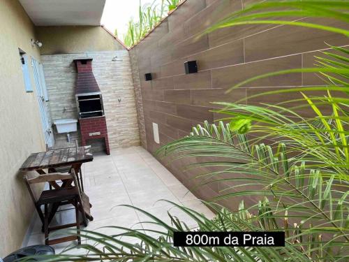 patio z ławką i ceglaną ścianą w obiekcie Rafael Apartamentos 800m da Praia da Maranduba w mieście Ubatuba
