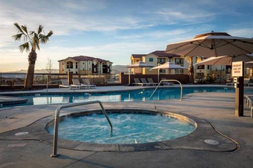 a swimming pool with a hot tub with an umbrella at Discover Zion Mountain, Private Hot Tub-3 Bedroom in Hurricane