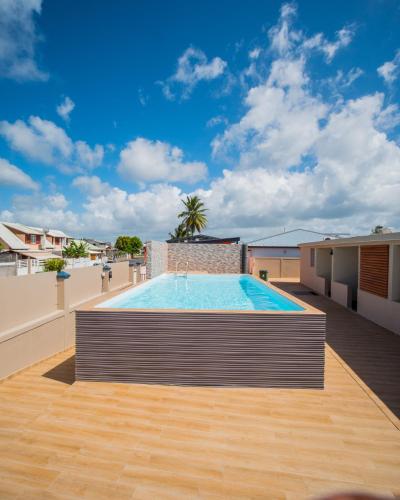 a swimming pool on the roof of a building at Evasion en plein cœur de la ville T3 Jacuzzis Sauna et piscine au centre de Port-Louis in Port-Louis