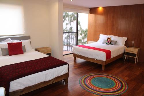 Un pat sau paturi într-o cameră la Casa Luna Coyoacan