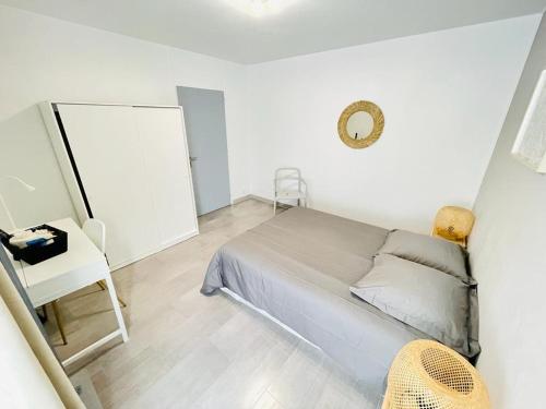 a bedroom with a bed and a table and a mirror at Flatshare 5 Colocation close to Geneva in Saint-Genis-Pouilly