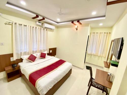 a bedroom with a bed and a television in it at Prabhuvihar Residency in Porvorim