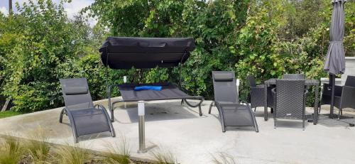 a patio with a table and chairs and an umbrella at Apartman for You in Gyenesdiás