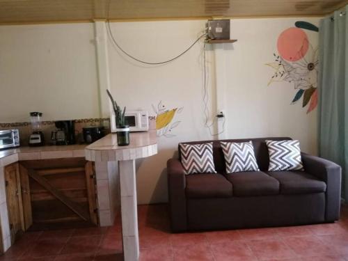 a living room with a couch and a table at La Casa del Río/La Fortuna/Volcán Arenal in San Ramón