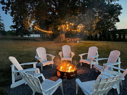 a group of chairs around a fire pit in a yard at The Prince Edward County Church in Belleville