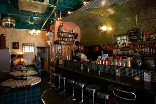 a bar with a row of stools at a counter at ABURA HAUS - Vacation STAY 13195 in Tokyo