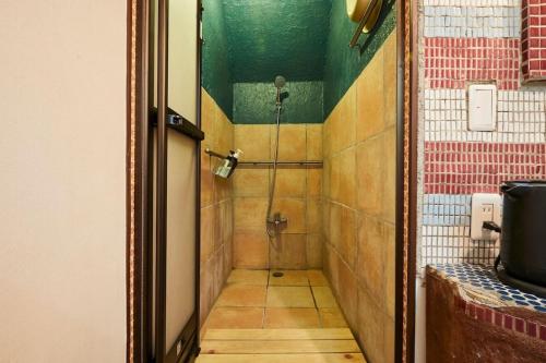 a shower stall in a bathroom with a tile wall at ABURA HAUS - Vacation STAY 13195 in Tokyo