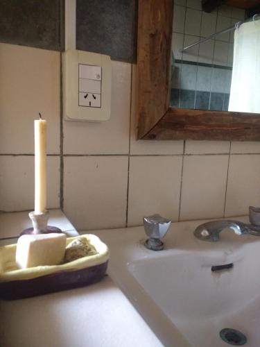 a bathroom with a candle on a sink at El Parralito in Mendoza