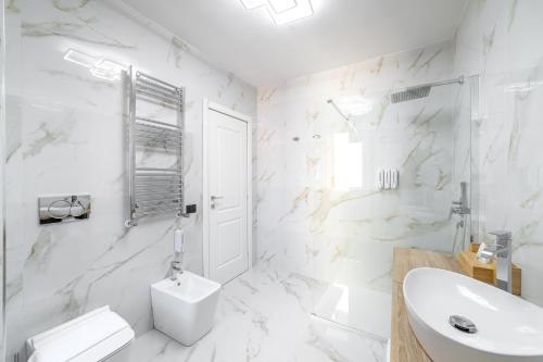a white bathroom with a toilet and a sink at iRoome in Rome