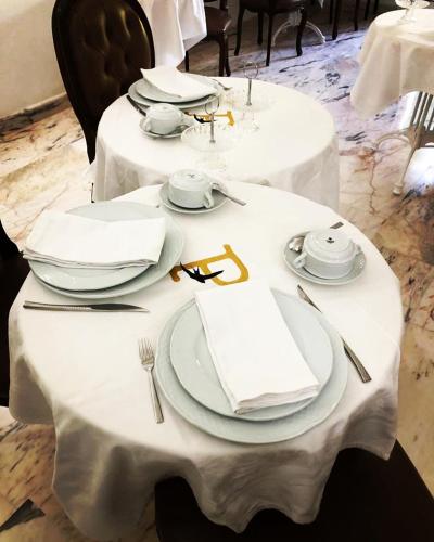 a table with white plates and napkins on it at Palacete Encanto Maior in Campo Maior