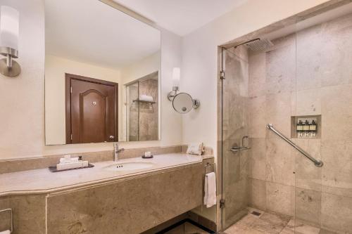 a bathroom with a sink and a shower at Fiesta Americana Merida in Mérida