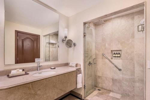 a bathroom with a sink and a shower at Fiesta Americana Merida in Mérida