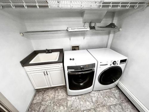 a washer and dryer sitting in a small kitchen at Newly Remodeled spacious units, minutes from mountains, inlet, downtown and airport in Anchorage