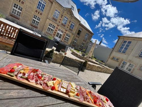 a tray of food sitting on top of a wooden table at Belle Normandy in Bayeux