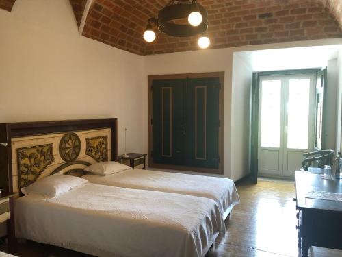 a bedroom with a large bed in a room at Quinta de Santa Barbara by Heavens Sleepy in Constância