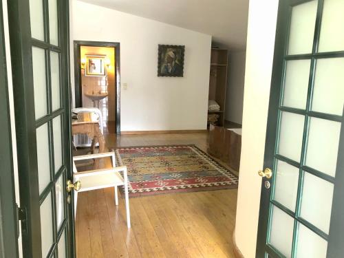 an open door to a living room with a rug at Quinta de Santa Barbara by Heavens Sleepy in Constância