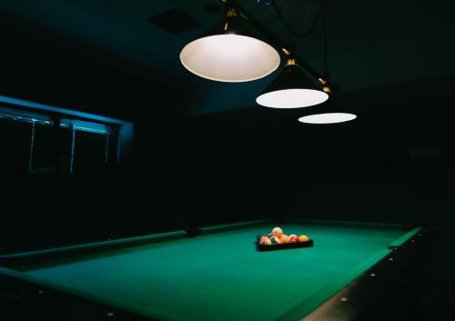 a room with a pool table with balls on it at Mtserlebi Resort in K'vishkhet'i