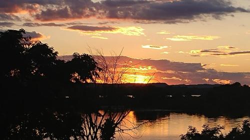 a sunset over a body of water at The Burlington Hotel & Bar - Alma WI in Alma