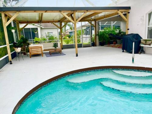 a swimming pool in the middle of a patio at Spacious 5BR Private Home, Private Pool & Salt Water Spa, Minutes from Beaches in Bradenton