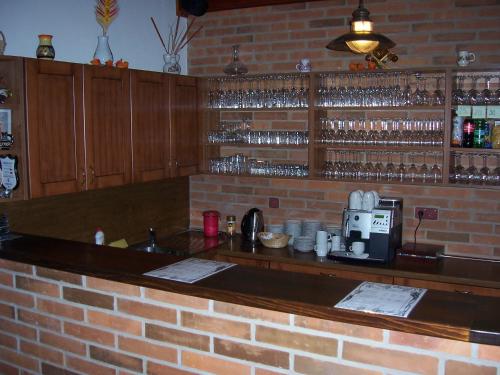a brick bar with a coffee maker on a brick wall at Penzion pod Kraví horou in Bořetice