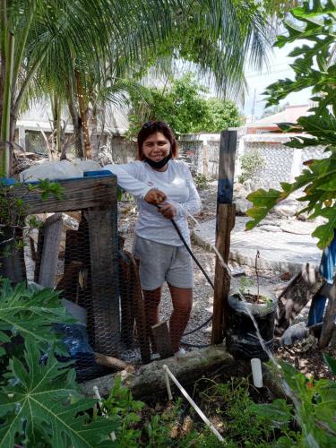 a man is standing next to a fence at Private Room in Cozumel