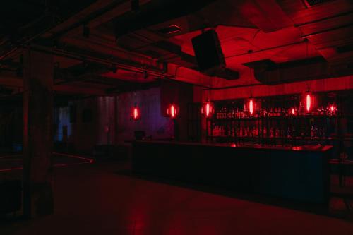 a red room with a bar with red lights at Mtserlebi Resort in K'vishkhet'i