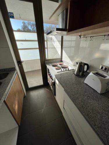 a small kitchen with a stove and a counter top at Departamento 2P 2B para 4 personas By Terrabahía in Copiapó